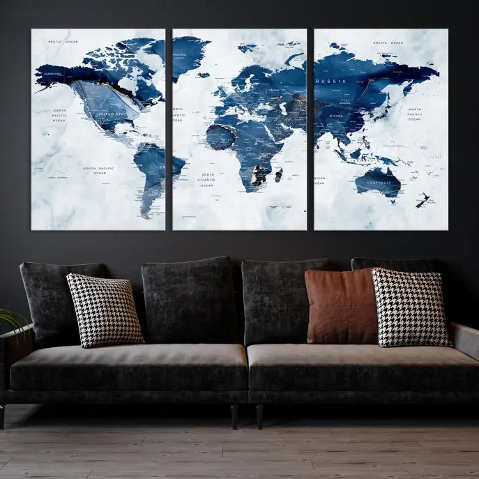 A beautifully gallery-wrapped Watercolor World Map Wall Art Canvas Print in dark blue hues hangs on the wall.