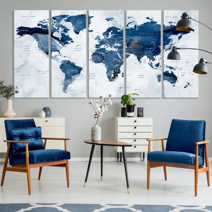 A beautifully gallery-wrapped Watercolor World Map Wall Art Canvas Print in dark blue hues hangs on the wall.