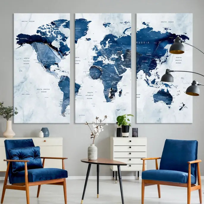 A beautifully gallery-wrapped Watercolor World Map Wall Art Canvas Print in dark blue hues hangs on the wall.