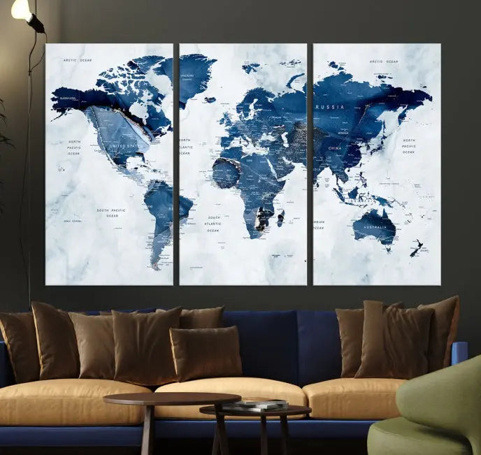 A beautifully gallery-wrapped Watercolor World Map Wall Art Canvas Print in dark blue hues hangs on the wall.