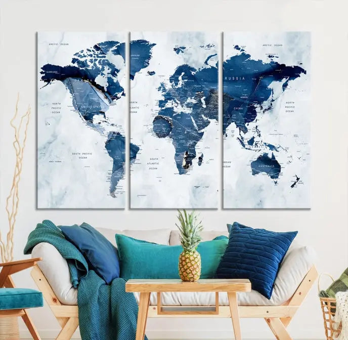 A beautifully gallery-wrapped Watercolor World Map Wall Art Canvas Print in dark blue hues hangs on the wall.