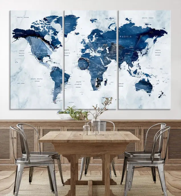 A beautifully gallery-wrapped Watercolor World Map Wall Art Canvas Print in dark blue hues hangs on the wall.