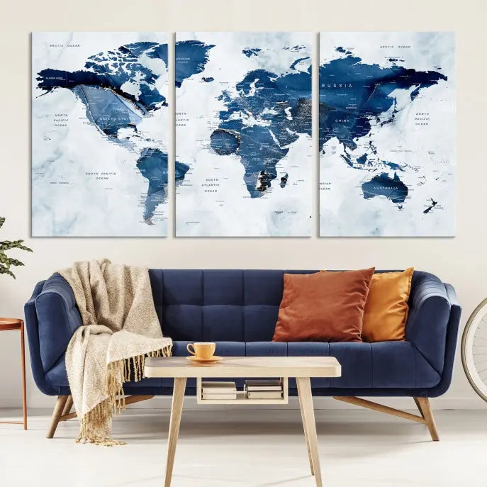 A beautifully gallery-wrapped Watercolor World Map Wall Art Canvas Print in dark blue hues hangs on the wall.