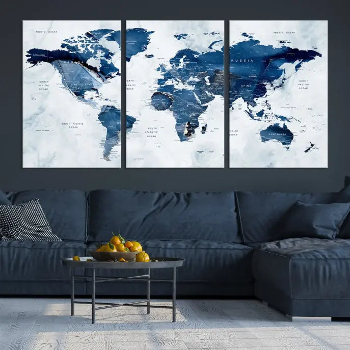 A beautifully gallery-wrapped Watercolor World Map Wall Art Canvas Print in dark blue hues hangs on the wall.