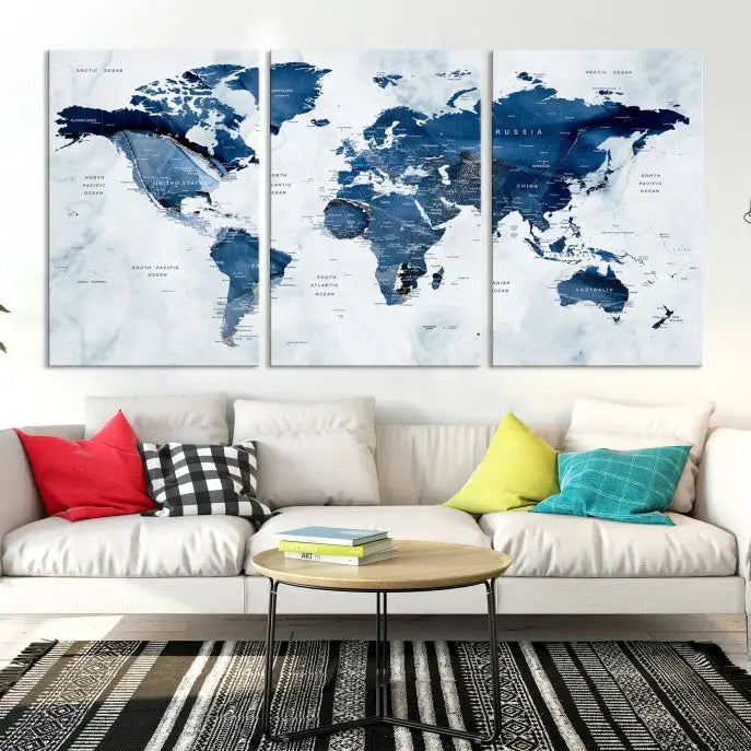 A beautifully gallery-wrapped Watercolor World Map Wall Art Canvas Print in dark blue hues hangs on the wall.