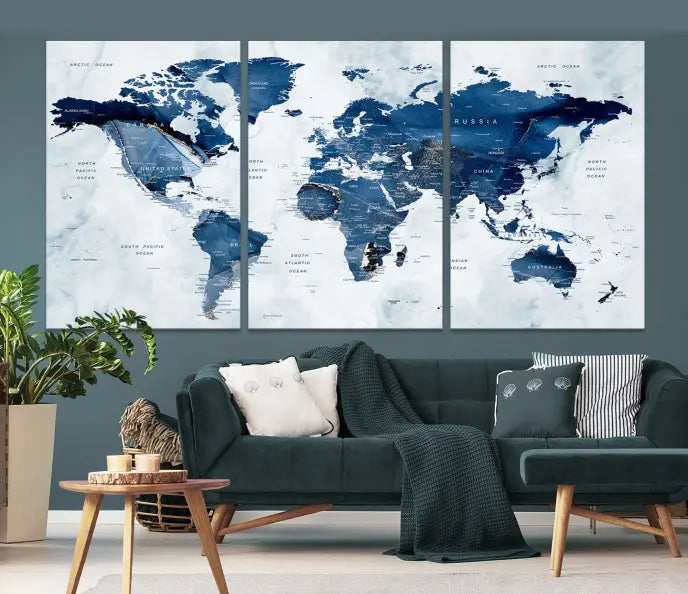 A beautifully gallery-wrapped Watercolor World Map Wall Art Canvas Print in dark blue hues hangs on the wall.