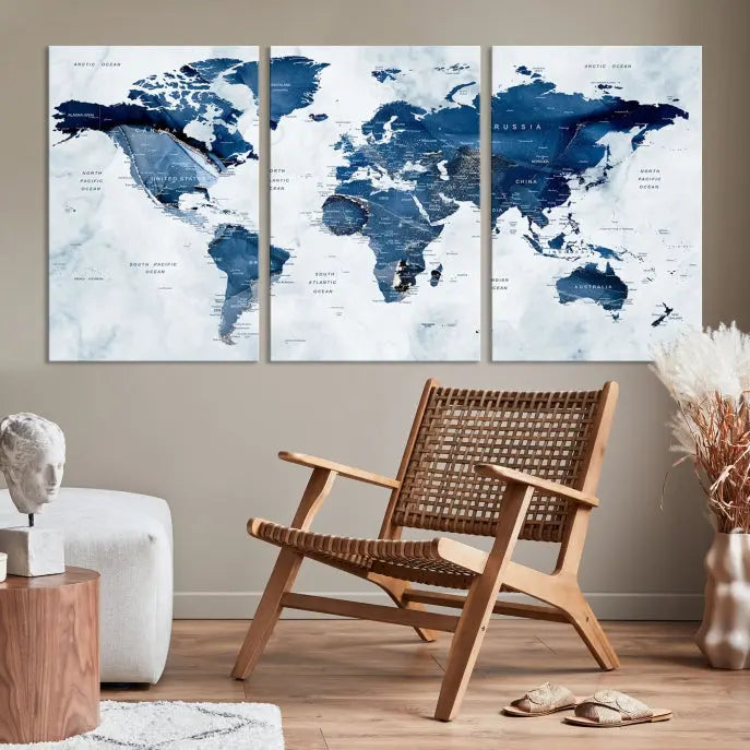 A beautifully gallery-wrapped Watercolor World Map Wall Art Canvas Print in dark blue hues hangs on the wall.