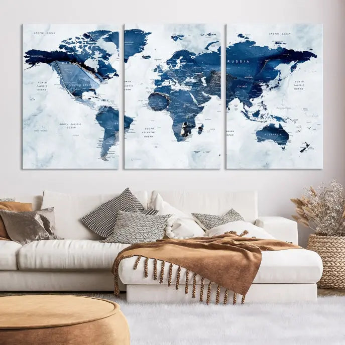 A beautifully gallery-wrapped Watercolor World Map Wall Art Canvas Print in dark blue hues hangs on the wall.