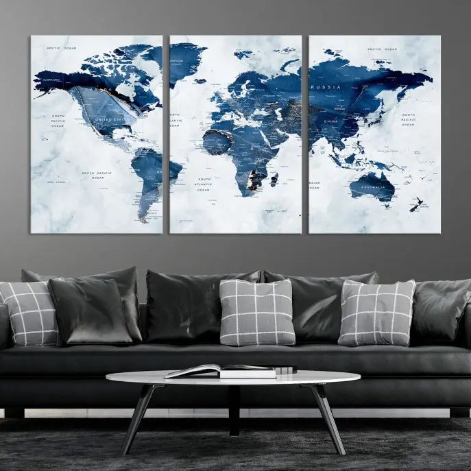 A beautifully gallery-wrapped Watercolor World Map Wall Art Canvas Print in dark blue hues hangs on the wall.