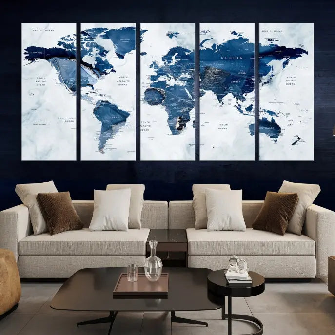 A beautifully gallery-wrapped Watercolor World Map Wall Art Canvas Print in dark blue hues hangs on the wall.