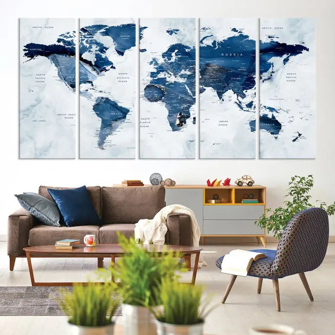 A beautifully gallery-wrapped Watercolor World Map Wall Art Canvas Print in dark blue hues hangs on the wall.