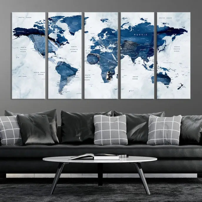 A beautifully gallery-wrapped Watercolor World Map Wall Art Canvas Print in dark blue hues hangs on the wall.