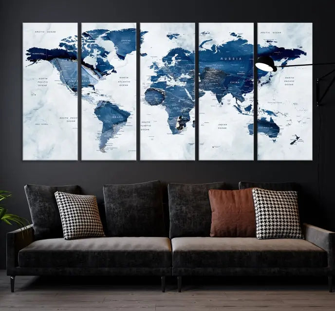 A beautifully gallery-wrapped Watercolor World Map Wall Art Canvas Print in dark blue hues hangs on the wall.