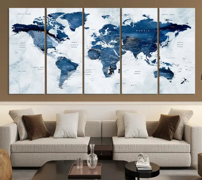 A beautifully gallery-wrapped Watercolor World Map Wall Art Canvas Print in dark blue hues hangs on the wall.