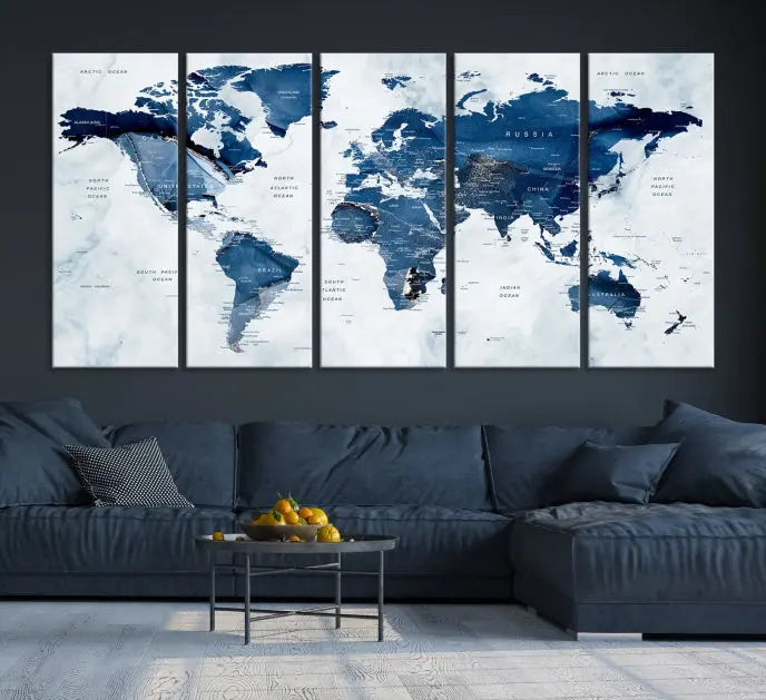 A beautifully gallery-wrapped Watercolor World Map Wall Art Canvas Print in dark blue hues hangs on the wall.