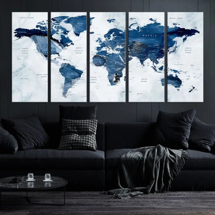 A beautifully gallery-wrapped Watercolor World Map Wall Art Canvas Print in dark blue hues hangs on the wall.