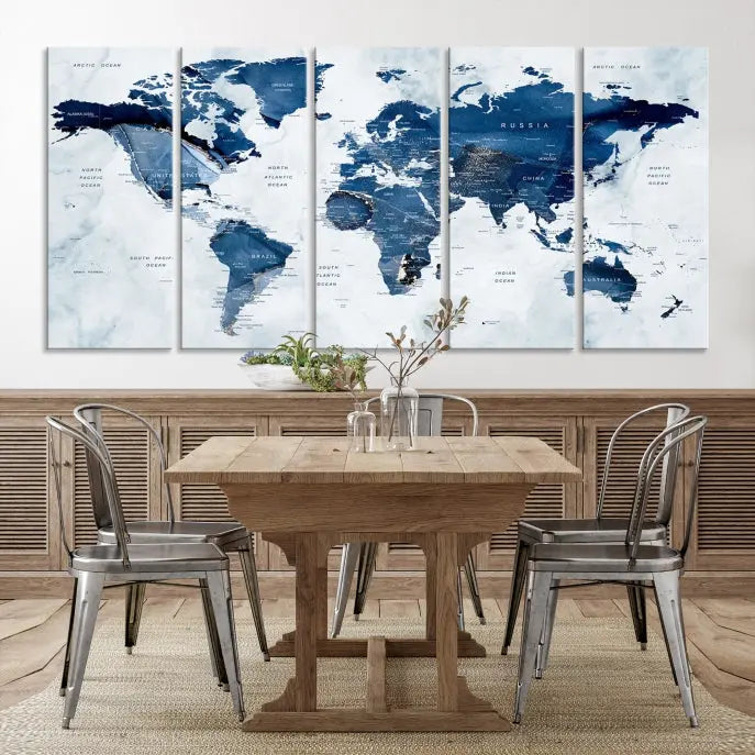 A beautifully gallery-wrapped Watercolor World Map Wall Art Canvas Print in dark blue hues hangs on the wall.