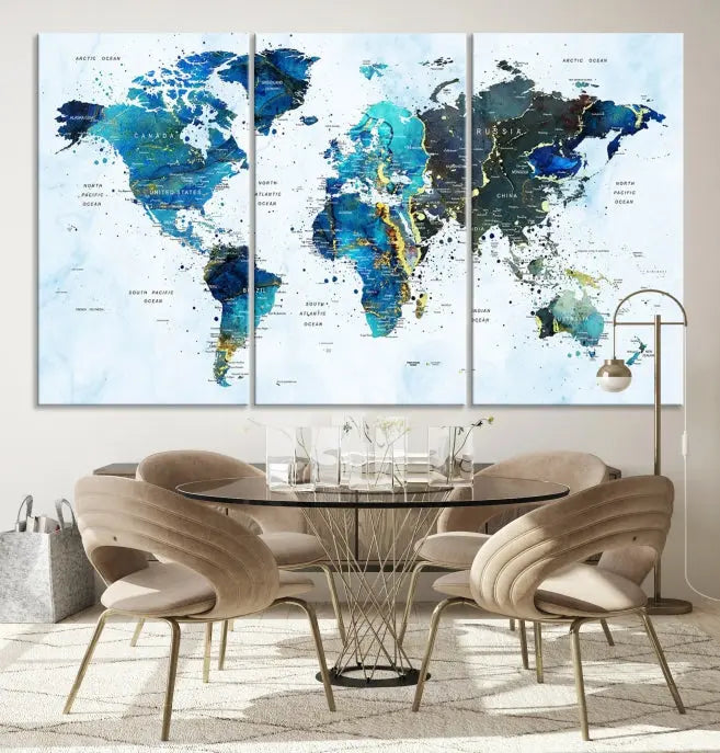 A Watercolor World Map Wall Art Canvas Print, arranged as a gallery-wrapped triptych in soothing blue and green tones, is displayed prominently.