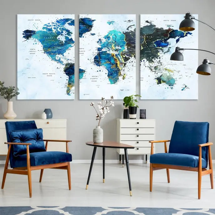 A Watercolor World Map Wall Art Canvas Print, arranged as a gallery-wrapped triptych in soothing blue and green tones, is displayed prominently.