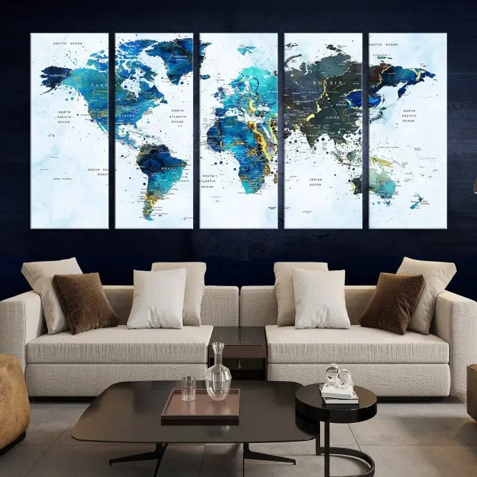 A Watercolor World Map Wall Art Canvas Print, arranged as a gallery-wrapped triptych in soothing blue and green tones, is displayed prominently.