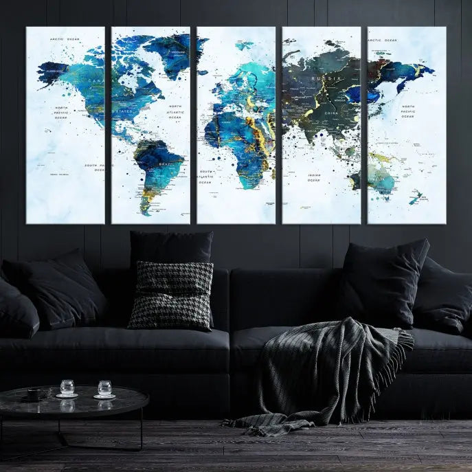 A Watercolor World Map Wall Art Canvas Print, arranged as a gallery-wrapped triptych in soothing blue and green tones, is displayed prominently.