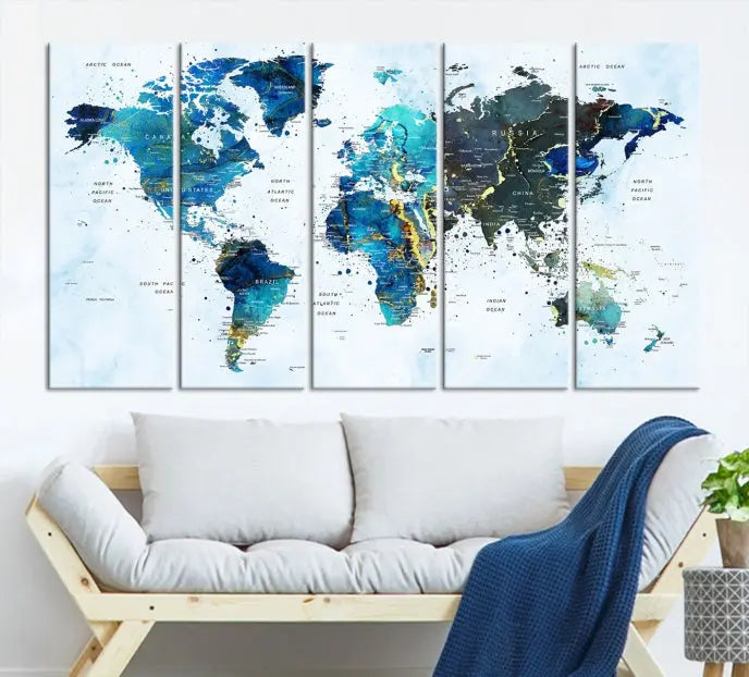 A Watercolor World Map Wall Art Canvas Print, arranged as a gallery-wrapped triptych in soothing blue and green tones, is displayed prominently.