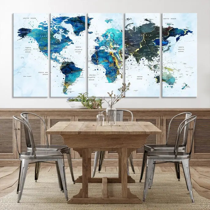 A Watercolor World Map Wall Art Canvas Print, arranged as a gallery-wrapped triptych in soothing blue and green tones, is displayed prominently.