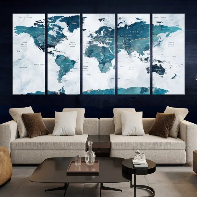 The Watercolor World Map Wall Art Canvas Print, rendered in blue tones and crafted on museum-quality canvas with a UV-protective coating, is elegantly displayed on the wall.