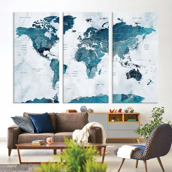 The Watercolor World Map Wall Art Canvas Print, rendered in blue tones and crafted on museum-quality canvas with a UV-protective coating, is elegantly displayed on the wall.