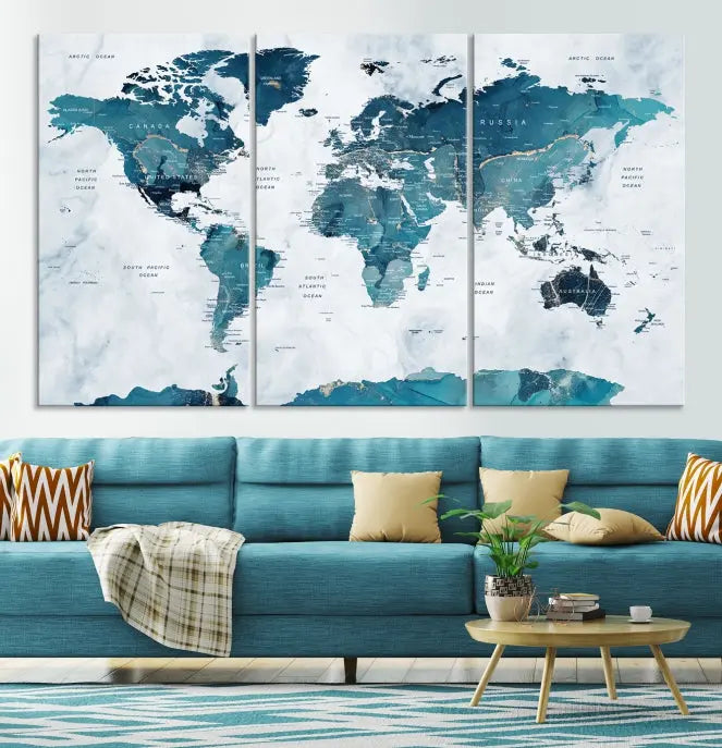 The Watercolor World Map Wall Art Canvas Print, rendered in blue tones and crafted on museum-quality canvas with a UV-protective coating, is elegantly displayed on the wall.