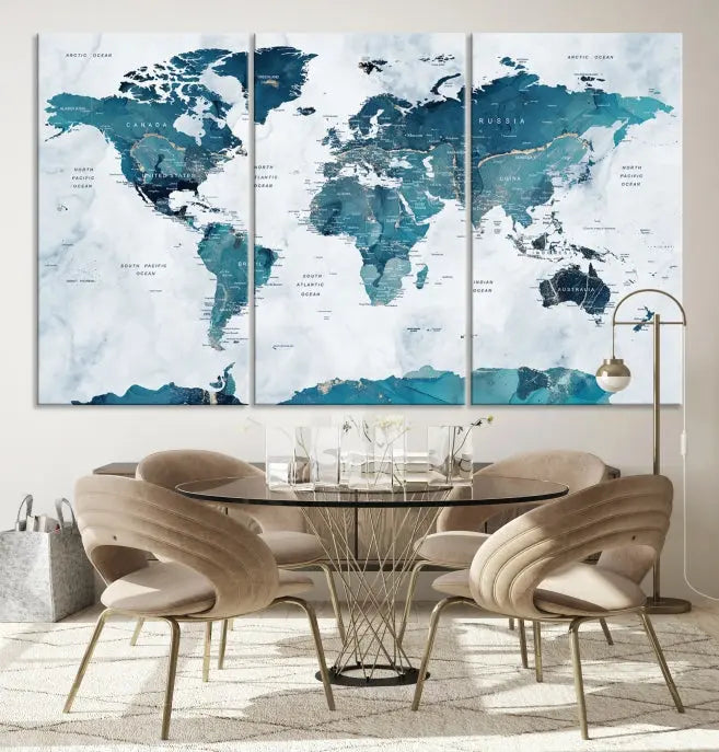 The Watercolor World Map Wall Art Canvas Print, rendered in blue tones and crafted on museum-quality canvas with a UV-protective coating, is elegantly displayed on the wall.