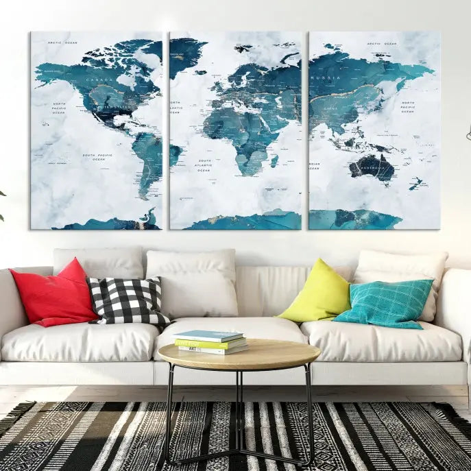 The Watercolor World Map Wall Art Canvas Print, rendered in blue tones and crafted on museum-quality canvas with a UV-protective coating, is elegantly displayed on the wall.