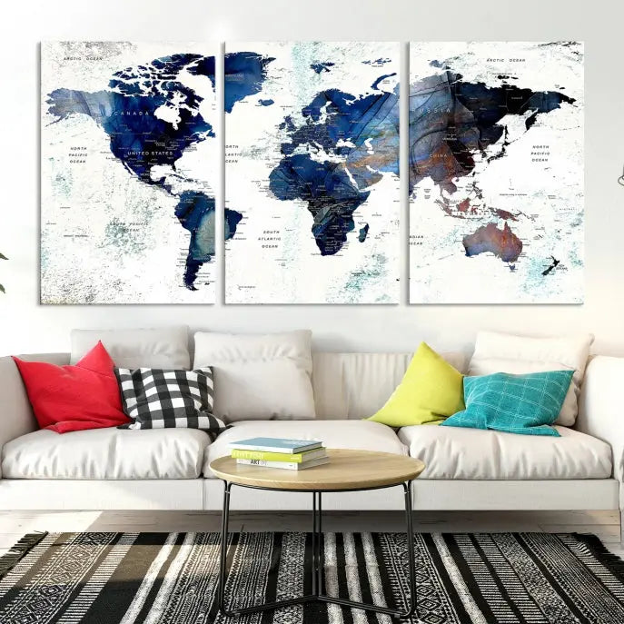 A modern living room showcases a Watercolor World Map Wall Art Canvas Print on the wall, crafted on museum-quality canvas. This artwork adds elegance to the space.