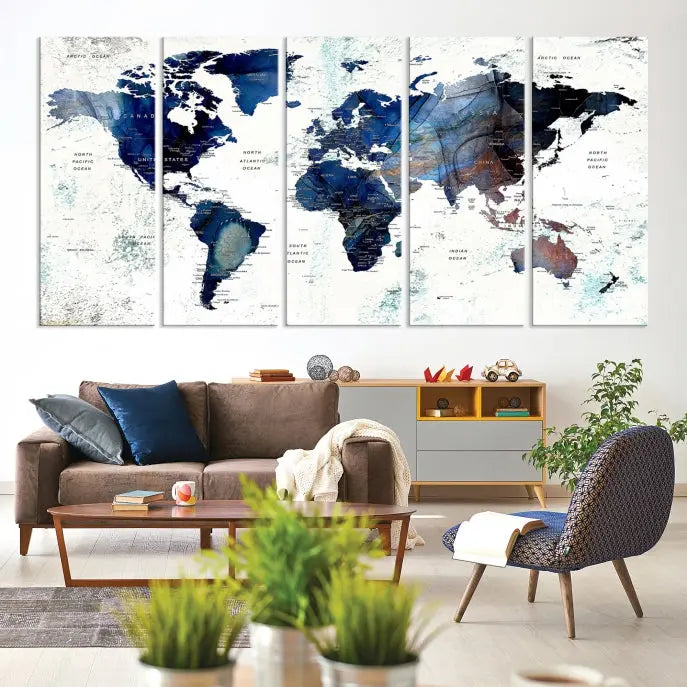 A modern living room showcases a Watercolor World Map Wall Art Canvas Print on the wall, crafted on museum-quality canvas. This artwork adds elegance to the space.