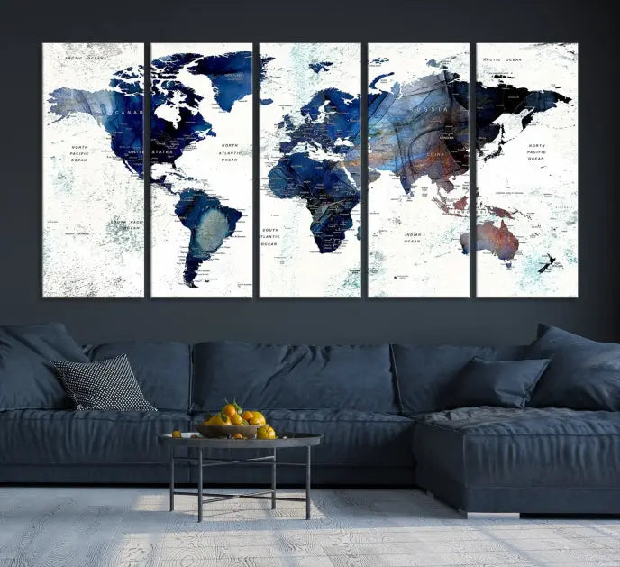 A modern living room showcases a Watercolor World Map Wall Art Canvas Print on the wall, crafted on museum-quality canvas. This artwork adds elegance to the space.