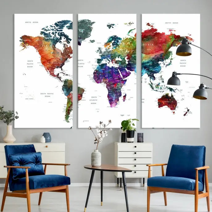 The "Watercolor World Map Wall Art Canvas Print," crafted by professional artisans, features three vibrant panels on museum-quality canvas, adorning the wall in a chic, minimalist room.