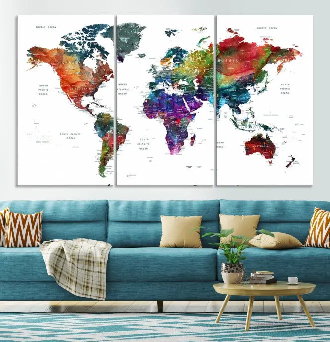 The "Watercolor World Map Wall Art Canvas Print," crafted by professional artisans, features three vibrant panels on museum-quality canvas, adorning the wall in a chic, minimalist room.