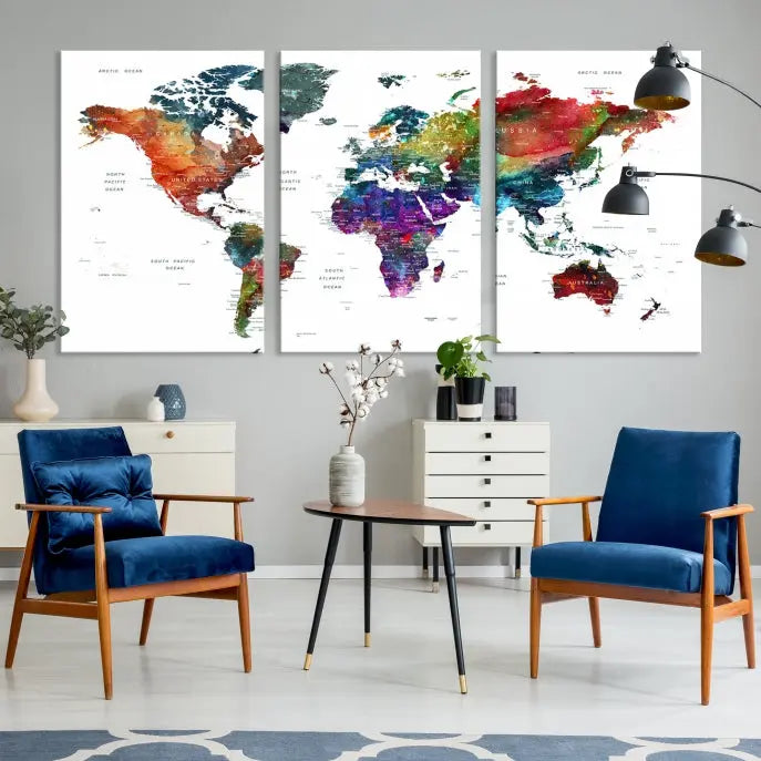 The "Watercolor World Map Wall Art Canvas Print," crafted by professional artisans, features three vibrant panels on museum-quality canvas, adorning the wall in a chic, minimalist room.