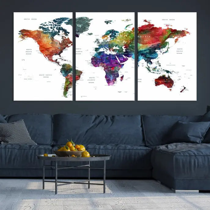 The "Watercolor World Map Wall Art Canvas Print," crafted by professional artisans, features three vibrant panels on museum-quality canvas, adorning the wall in a chic, minimalist room.