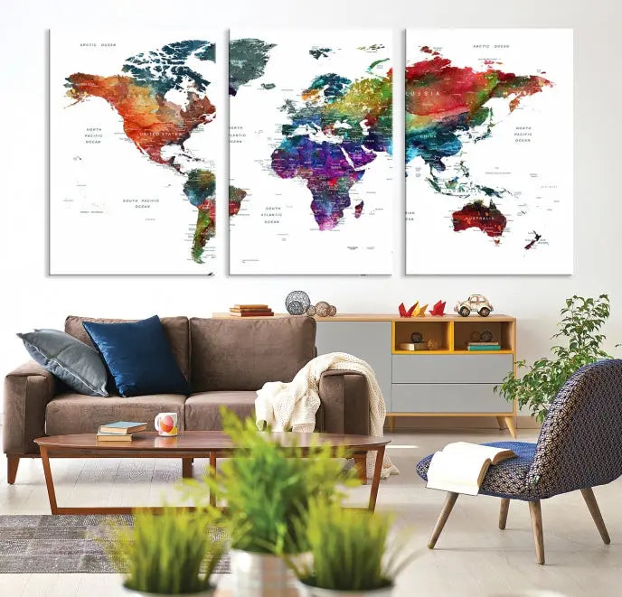 The "Watercolor World Map Wall Art Canvas Print," crafted by professional artisans, features three vibrant panels on museum-quality canvas, adorning the wall in a chic, minimalist room.