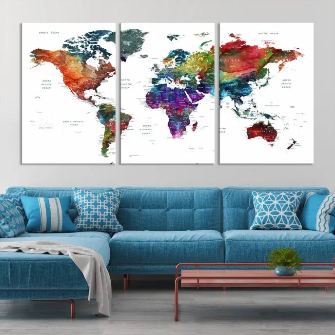 The "Watercolor World Map Wall Art Canvas Print," crafted by professional artisans, features three vibrant panels on museum-quality canvas, adorning the wall in a chic, minimalist room.