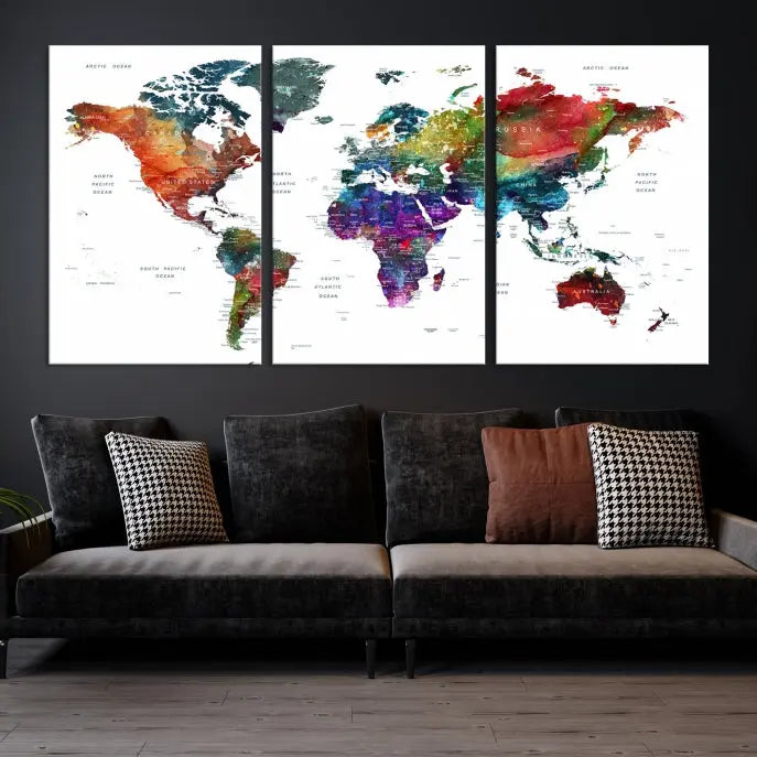 The "Watercolor World Map Wall Art Canvas Print," crafted by professional artisans, features three vibrant panels on museum-quality canvas, adorning the wall in a chic, minimalist room.