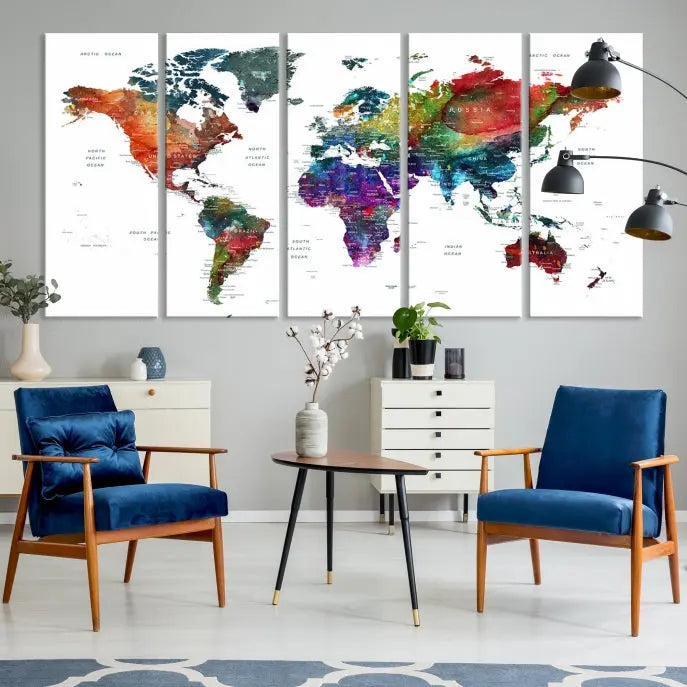 The "Watercolor World Map Wall Art Canvas Print," crafted by professional artisans, features three vibrant panels on museum-quality canvas, adorning the wall in a chic, minimalist room.