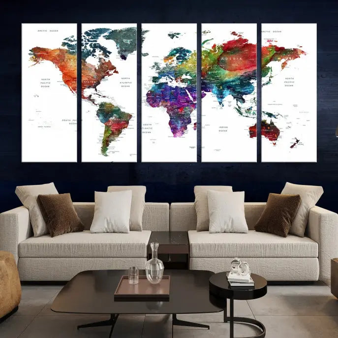 The "Watercolor World Map Wall Art Canvas Print," crafted by professional artisans, features three vibrant panels on museum-quality canvas, adorning the wall in a chic, minimalist room.