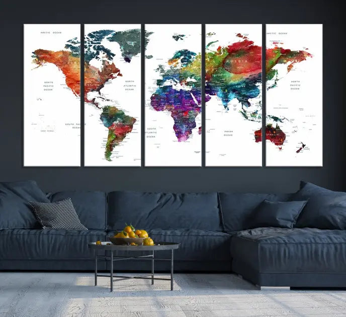 The "Watercolor World Map Wall Art Canvas Print," crafted by professional artisans, features three vibrant panels on museum-quality canvas, adorning the wall in a chic, minimalist room.