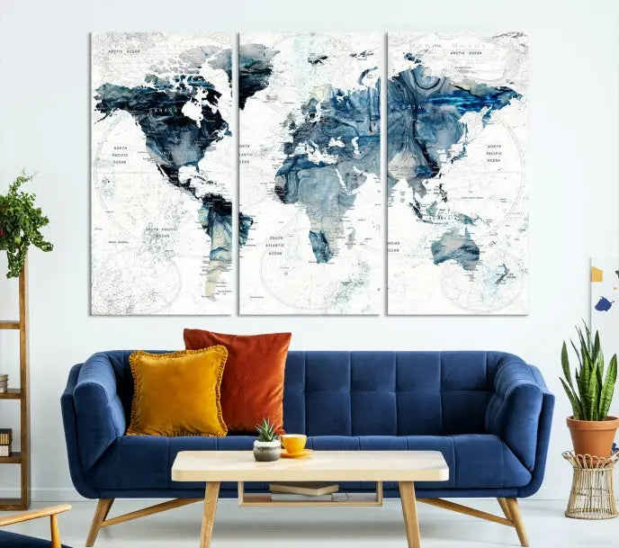 The Watercolor World Map Wall Art Canvas Print, a three-panel abstract masterpiece on museum-quality canvases, adorns the wall.