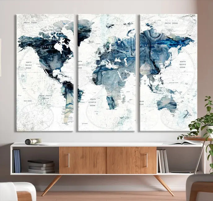 The Watercolor World Map Wall Art Canvas Print, a three-panel abstract masterpiece on museum-quality canvases, adorns the wall.