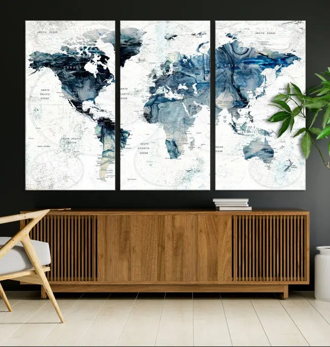 The Watercolor World Map Wall Art Canvas Print, a three-panel abstract masterpiece on museum-quality canvases, adorns the wall.