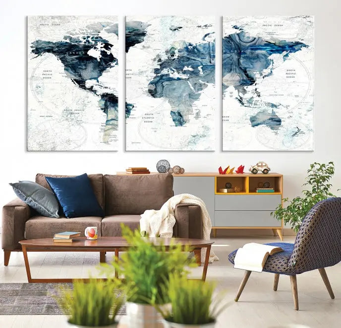 The Watercolor World Map Wall Art Canvas Print, a three-panel abstract masterpiece on museum-quality canvases, adorns the wall.