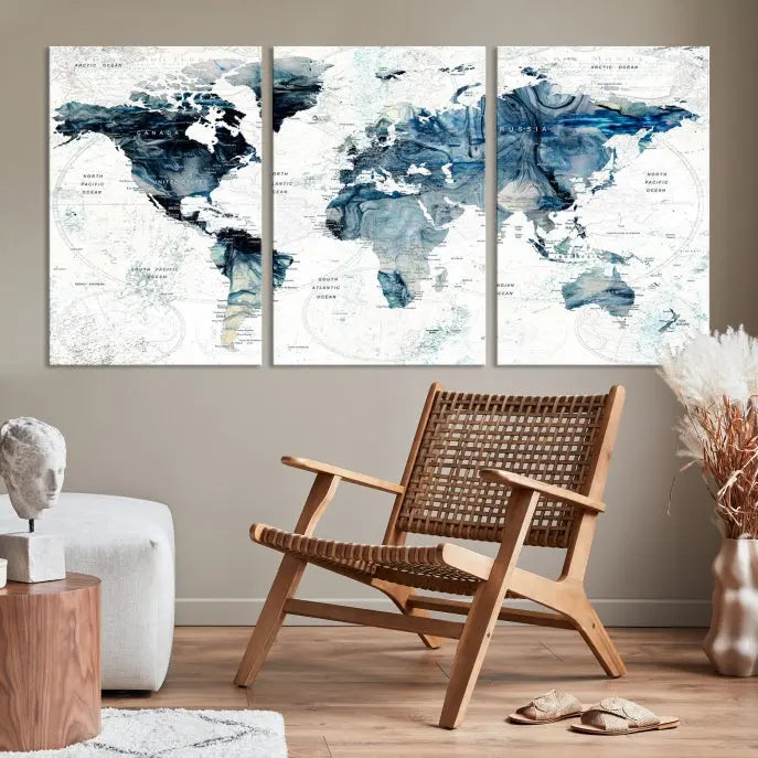 The Watercolor World Map Wall Art Canvas Print, a three-panel abstract masterpiece on museum-quality canvases, adorns the wall.